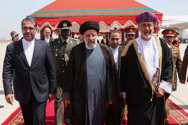 This photo shows  Sultan of Oman Haitham Bin Tariq Al Said (right) welcoming Iran's President Ebrahim Raisi (centre) at the airport in the Omani capital Muscat, on Monday (AFP photo)