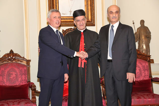 Christian Lebanese leaders Suleiman Frangieh and Samir Geagea shake hands accompanied by Patriarch Bechara Al Rai in Bkerki, Lebanon, on Wednesday (Reuters photo)