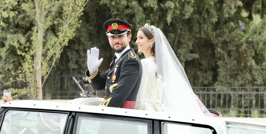 Their Royal Highnesses Crown Prince Hussein and Princess Rajwa Al Hussein greet the public during the Royal Red Motorcade procession following their wedding ceremony on Thursday (Photo by Osama Aqarbeh)