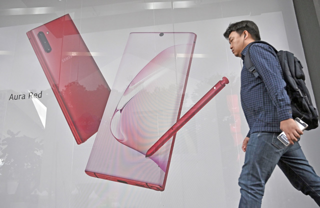 A man walks past an advertisement for the Samsung Galaxy Note10 5G smartphone in Seoul, on Tuesday  (AFP photo)