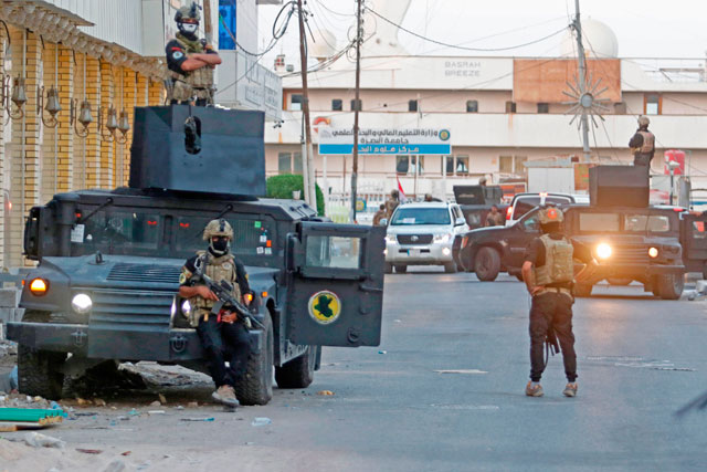 Iraqi anti-terrorism forces secure the street close to the Basra International Hotel where Iraqi Prime Minister Haider Al Abadi stays in Basra, on Monday (AFP Photo)