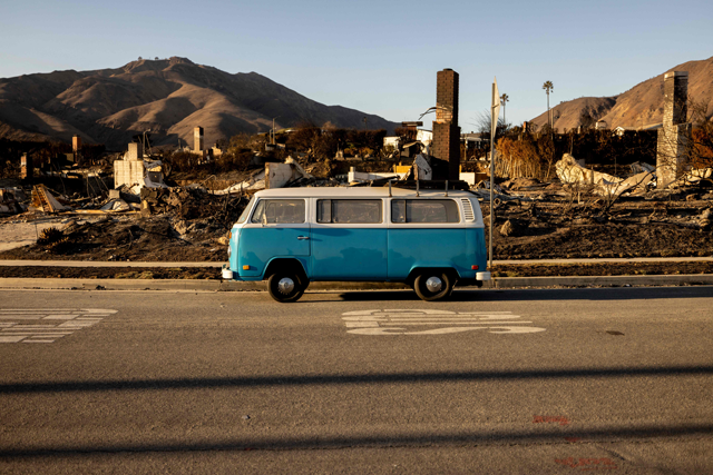 A blue Volkswagen van sits intact on a street amid homes destroyed by the Palisades Fire in Malibu, California, on January 15, 2025 (AFP photo)