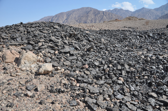   Looking east over an Early Islamic period copper slag mound at Khirbat Al Mana’iyya (Photo courtesy of Thomas E. Levy)