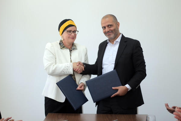 Ambassador of the Kingdom of the Netherlands to Jordan Barbara Joziasse and Waleed Al Tarawneh, president and CEO of Partners for Good shake hands during a signing ceremony on Wednesday (Photo courtesy of PfG)