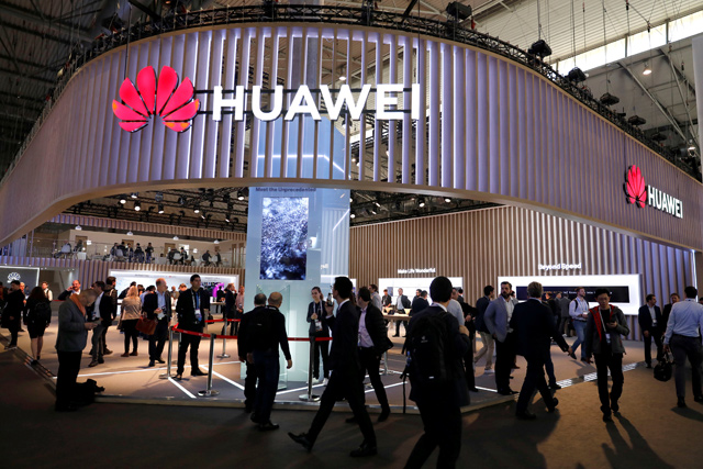 Visitors walk next to Huawei booth at the Mobile World Congress in Barcelona, Spain, on Wednesday (Reuters photo)