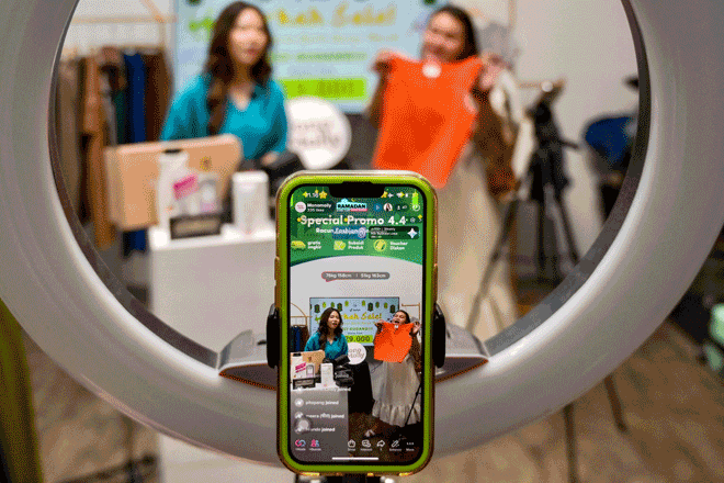 This photo taken on April 4, shows employees working for a TikTok channel offering merchandise for sale through a TikTok livestream at a room in Jakarta (AFP photo by Bay Ismoyo)