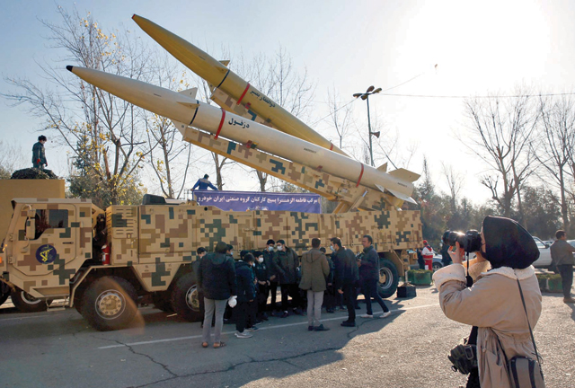 An Iranian woman takes a photo of Zolfaghar-Basir and Dezful missiles displayed at Mosallah Mosque on the occasion of second anniversary of an Iran missile attack at a US military base in Iraq following the assassination of a former top Iranian commander, in Tehran, on January 7 (AFP photo)
