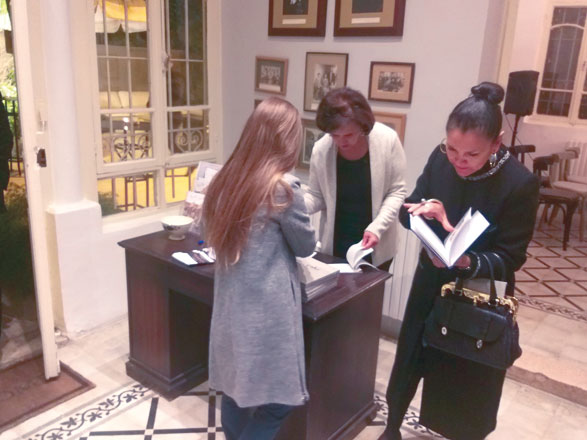 Event attendees peruse the book ‘Cake: The dessert culture between Arab and Western tradition’, which was presented by the Italian embassy at NOFA Creative Space on Monday  (Photo courtesy of Italian embassy)