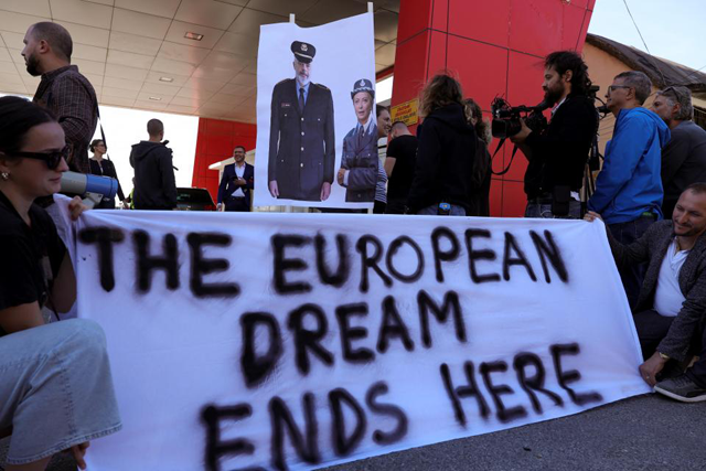 A group of civil rights activists gather in protest, after the first group migrants intercepted in Italian waters, arrived at Shengjin port in Albania on October 16 (AFP photo)