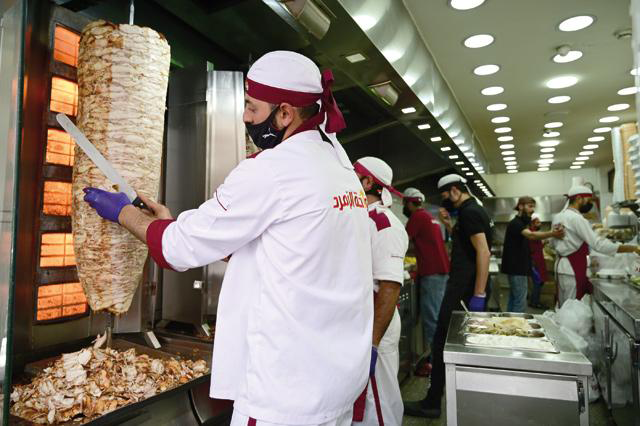 An employee at an Amman restaurant prepares shawerma in this file photo (File photo)