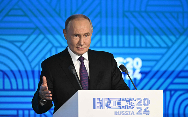In this pool photograph distributed by the Russian state agency Sputnik, Russia's President Vladimir Putin gives a speech during a BRICS business forum in Moscow on October 18, 2024 (AFP photo)