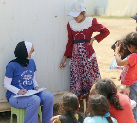 Hala Allawama, the founder of the Healthy Teeth Project, with children at a refugee camp in northern Jordan (Photo courtesy of Hala Allawama)