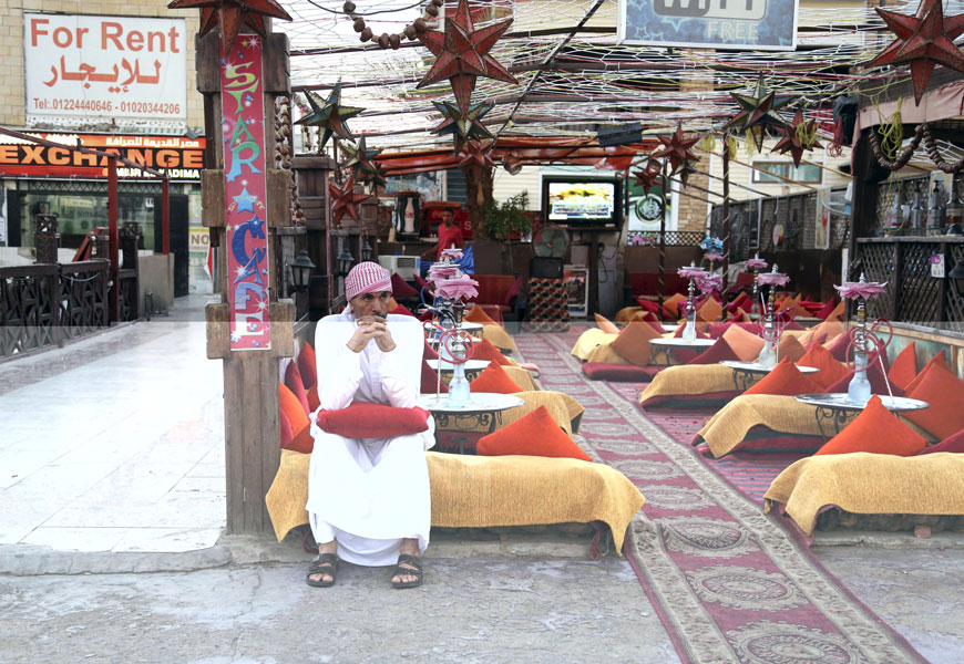 A cafe employee sits waiting for customers at the Red Sea resort of Sharm  El Sheikh on Thursday  (Reuters photo)