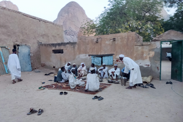 Men gather for the Iftar, or fast-breaking meal, provided at the mausoleum and mosque of Al Sayyid Al Hasan, or Sheikh Hassan Al Mirghani, one of the leaders of the Khatmiyya Sufi order founded in 1817, in Sudan's eastern city of Kassala on the first day of the Muslim holy month of Ramadan on Saturday (AFP photo)