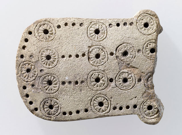 Fragmentary game of 58 hole from Luristan, Iran, at the Louvre Museum in Paris, France (Photo courtesy of Louvre Museum)