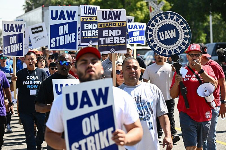 Members of the United Auto Workers (UAW) Local 230 and their supporters walk the picket line in front of the Chrysler Corporate Parts Division in Ontario, California, on September 26, to show solidarity for the 'Big Three' autoworkers currently on strike (AFP file photo)