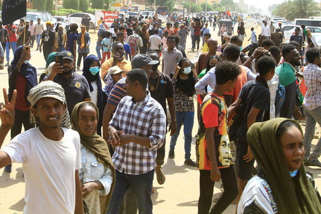 People march in a demonstration demanding the return of civilian rule, near the airport in the south of Sudan's capital Khartoum on Thursday (AFP photo)