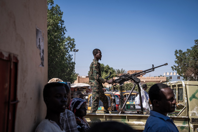 A Sudanese army soldier mans a machine gun on top of a military pickup truck outside a hospital in Omdurman on November 2  (AFP photo)