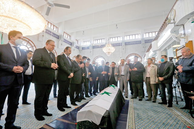 Mourners pray by the coffin of late Syrian foreign minister Walid Muallem at the Saad Ibn Mouadh Mosque, during his funeral in the capital Damascus, on Monday (AFP photo)