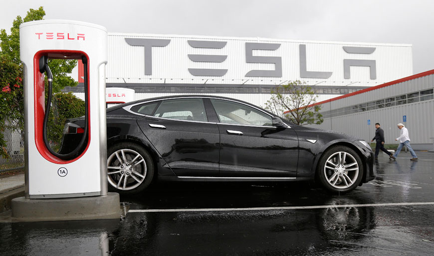 In this May 14 photo, a Tesla vehicle is parked at a charging station outside of the Tesla factory in Fremont, California (AP photo)