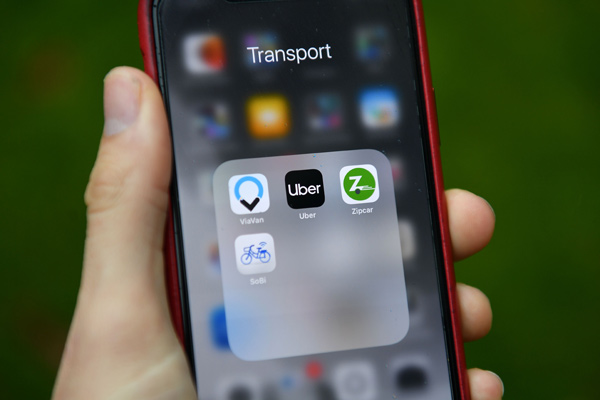 Transport apps including Uber and Zipcar are seen on a smartphone in London on Monday  (AFP photo)