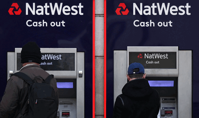 Customers use an ATM machine outside branch of a Natwest bank, in central London, on Tuesday (AFP photo)