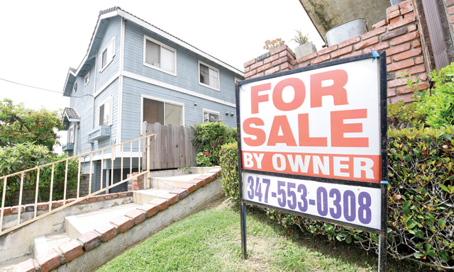 A ‘For Sale by Owner’ sign is posted in front of property in Monterey Park, California, on April 29 (AFP photo)