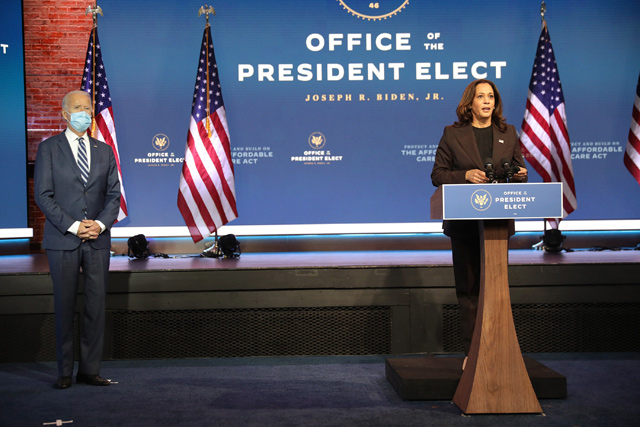 US President-elect Joe Biden listens as Vice President-elect Kamala Harris addresses the media about the Trump Administrations lawsuit to overturn the Affordable Care Act on Tuesday at the Queen Theater in Wilmington, Delaware (AFP photo)