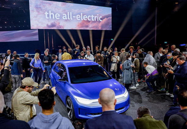 Visitors take photos of the new ID 2 electric car model, during its presentation at the Congress Centre  in Hamburg on Wednesday (AFP photo)