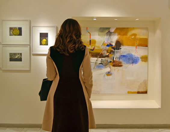 An Orient Gallery visitor examines a piece in the ‘Aesthetics’ exhibition on Tuesday (Photo by Yasmeen Kanaan)