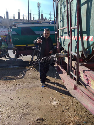 A Water and Irrigation Ministry official inspects a water tanker (Photo courtesy of the Ministry of Water and Irrigation)