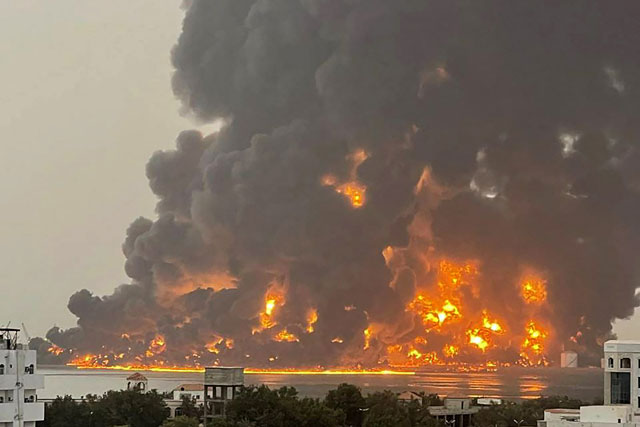 A handout photo obtained from Yemen's Houthi Ansarullah Media Center show a huge column of fire erupting following reported strikes in the Yemeni rebel-held port city of Hodeida on Saturday (AFP photo)