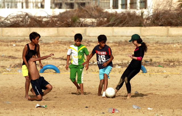 Children play on the beach along the coast of the eastern Libyan port city of Benghazi on Saturday (AFP photo)