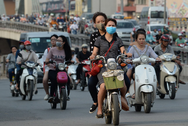 Motorcyclists ride at rush hour on a street in downtown Hanoi on Tuesday (AFP photo)