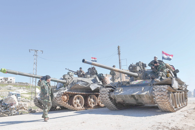 Syrian army units advance in the town of Al Eis in south Aleppo province on Sunday, following battles with rebels and extremists (AFP photo)