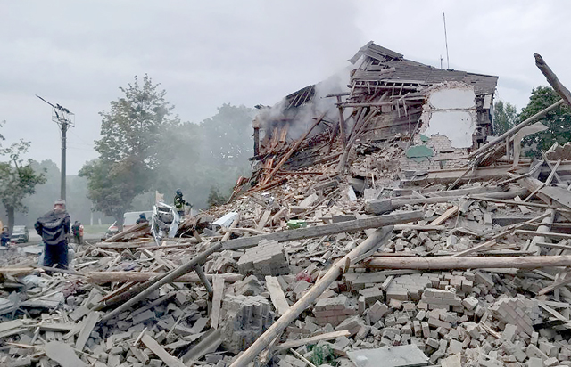 This handout photo taken and released by Ukrainian emergency service on Saturday, shows firefighters removing rubble from a destroyed building after a missile strike in the city of Nikopol, Dnipro region (AFP photo)