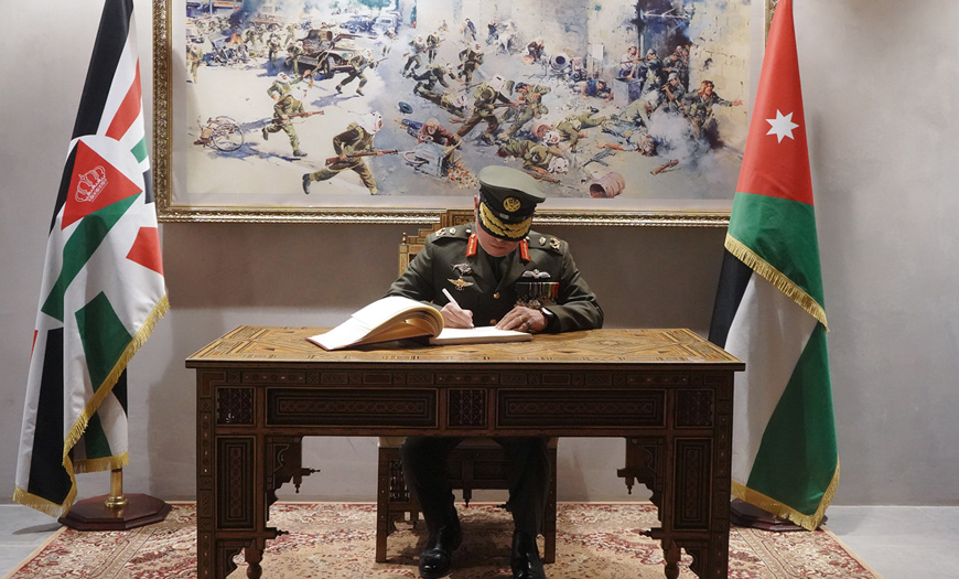 His Majesty King Abdullah, the Supreme Commander of the Jordan Armed Forces-Arab Army, signs the guestbook at the Martyr’s Memorial on Wednesday (Photo courtesy of Royal Court)