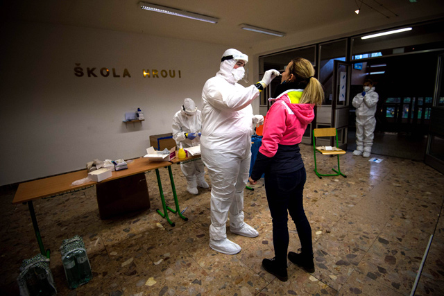 A medic tests a woman for the novel coronavirus COVID-19 during nationwide testing in Bratislava, Slovakia, on Saturday (AFP photo)