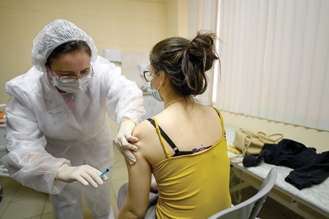 A nurse wearing a face mask proceeds to a vaccination against the coronavirus disease (COVID-19) by Sputnik V (Gam-COVID-Vac) vaccine at a clinic in Moscow on Saturday, amid the ongoing coronavirus disease pandemic (AFP photo)