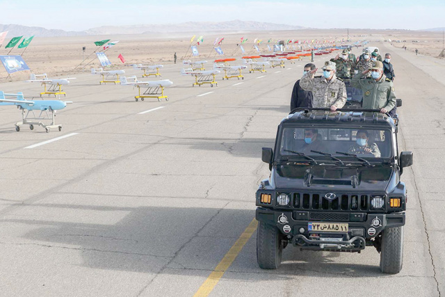 This handout photo made available by the Iranian army office on Tuesday shows military officials inspecting drones on display prior to a military drone drill at an undisclosed location in central Iran (AFP photo)