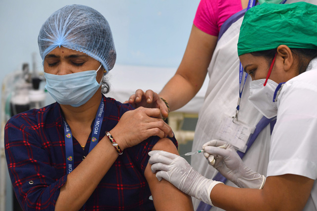 A medical worker inoculates a colleague with a COVID-19 coronavirus vaccine at the Rajawadi Hospital in Mumbai on Saturday (AFP photo)