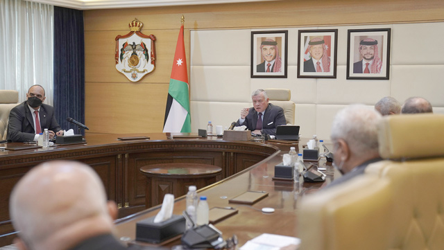 His Majesty King Abdullah chairs part of a Cabinet meeting during a visit to the Prime Ministry on Monday (Photo courtesy of Royal Court)