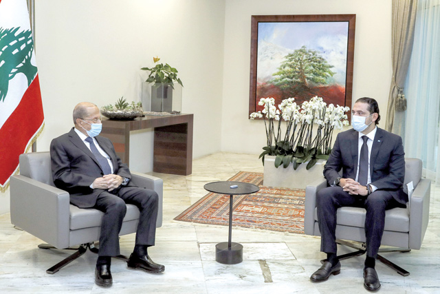 This handout photo provided by the Lebanese photo agency Dalati and Nohra on Monday, shows Lebanese President Michel Aoun (left) meeting with prime minister-designate Saad Hariri at the presidential palace in Baabda, east of the capital Beirut (AFP photo)