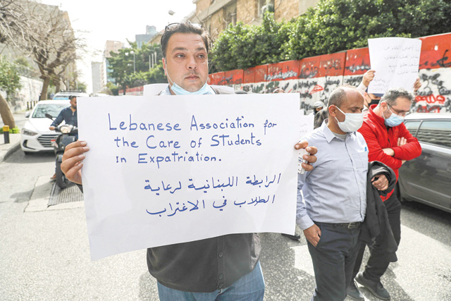 Relatives of Lebanese students studying abroad demonstrate outside the headquarters of the Banque du Liban (Lebanese Central Bank) in the capital Beirut, on Wednesday (AFP photo)