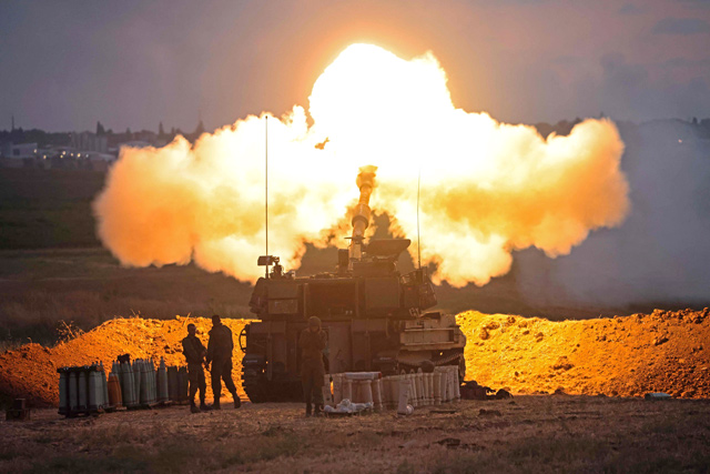 Israeli forces fire a 155mm self-propelled howitzer towards the Gaza Strip from their position along the border with the Palestinian enclave on Monday (AFP photo)