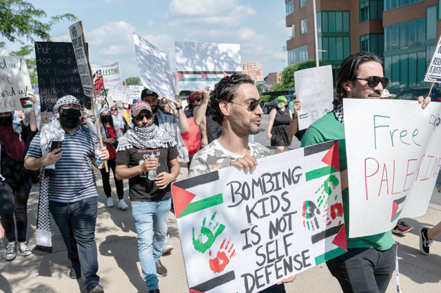 People chant and hold signs in support of Palestine during a protest march from Waterfront Park to City Hall on Sunday in Louisville, Kentucky (AFP photo)