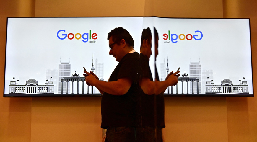 This file photo taken on January 22, 2019, shows a man standing in front of a screen picturing Berlin landmarks during the opening day of a new Berlin office of US Internet search giant Google in Berlin (AFP photo)