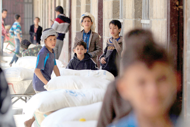 Yemenis receive humanitarian aid provided by the World Food Programme in the Yemeni capital Sanaa on Tuesday (AFP photo)