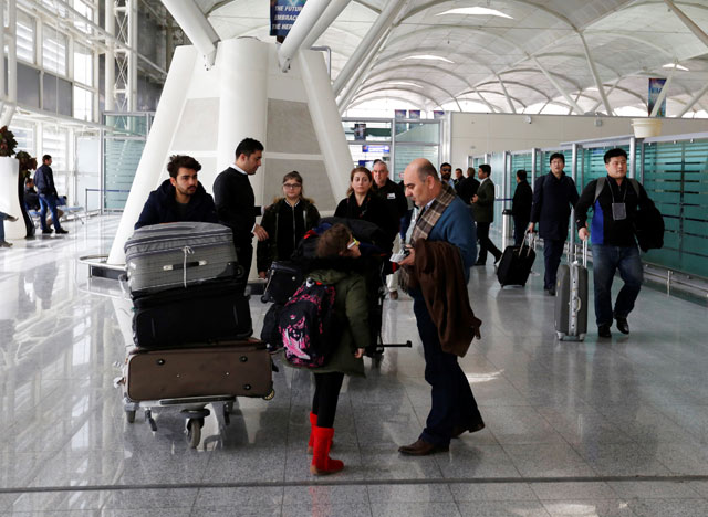 Fuad Sharef and his family push their belongings after returning to Iraq from Egypt, where they were prevented from boarding a plane to the US, following US President Donald Trump’s decision to temporarily bar travellers from seven countries, including Iraq, at Erbil International Airport, Iraq, on Sunday (Reuters photo)