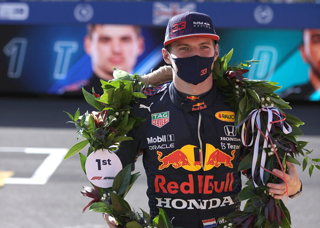 Red Bull’s Dutch driver Max Verstappen wears the winner’s laurel wreath as he celebrates attaining pole position for the Formula One British Grand Prix at the Silverstone motor racing circuit in Silverstone, central England, on Saturday (AFP photo by Lars Baron)
